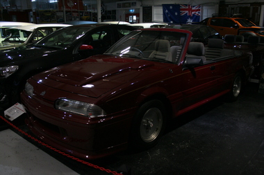 Burgundy coloured VL Commodore 2 door. Grey velour upholstery, no roof.