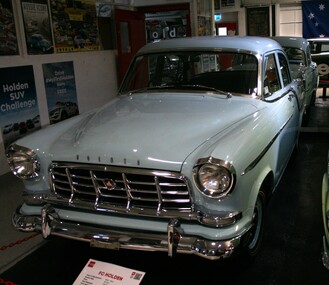 Green bodied car, white roof, chrome bumper and features