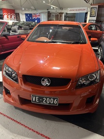 VE Commodore SSV four door sedan. The colour is known as Ignition, (a distinctive orange ) car has inbuilt fog lamps low on the front bumper, and a boot mounted wing. This car was displayed eight days before the "official" release of the VE model