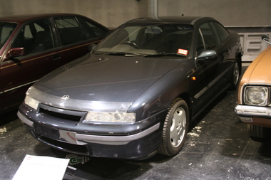 2 Door sedan with glass sunroof, navy blue finish to body, high polish alloy wheels.