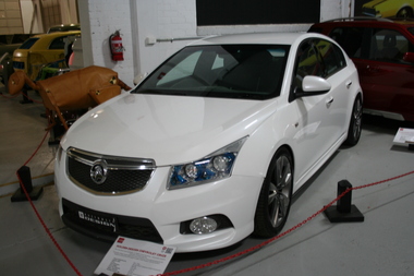 White painted 4 door hatchback sedan, 5 spoke alloy wheels, Low mounted on front bumper fog lamps