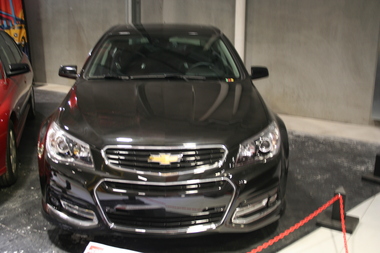 Black coloured 4 door sedan, with sunroof and wind deflector mounted on boot lid. Grille and fog lamps mounted in front bumper .   Car is left hand drive.                                                                                                                             