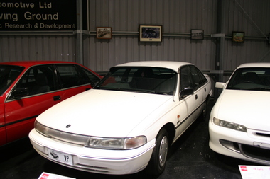 White painted Commodore with sunscreen over front windscreen, wind deflectors at each of the front windows