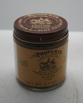 Glass jar containing boot cream