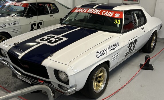 White HQ Monaro Racing Car with black stripe and gold wheels