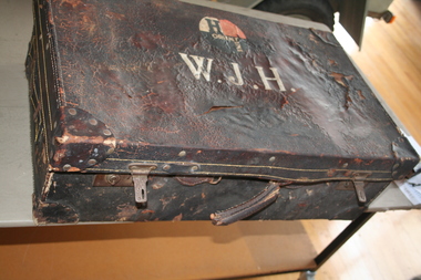 Brown leather suitcase used by travellers