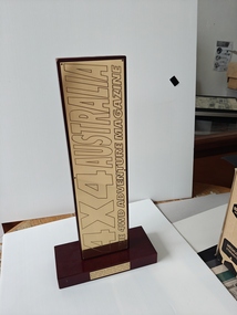 brass plaque on timber stand