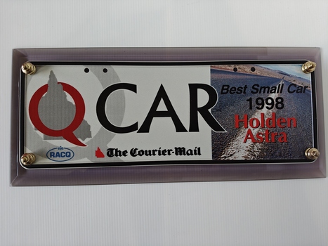 number plate bolted to acrylic base