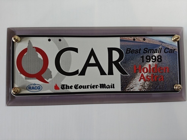 number plate bolted to acrylic base