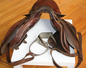 
Stock saddle with stirrups and stirrup leathers







