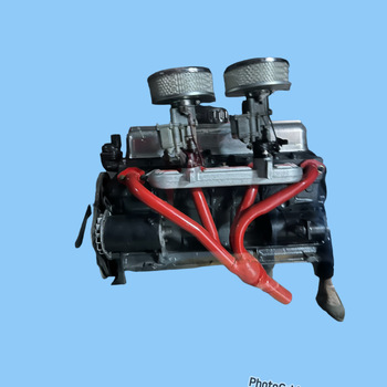 Grey and red motor with twin carburetor