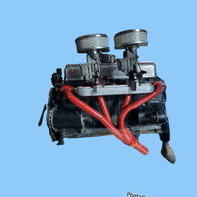 Grey and red motor with twin carburetor