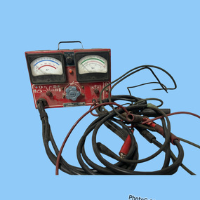 Red an black metal box with gauges and chargers