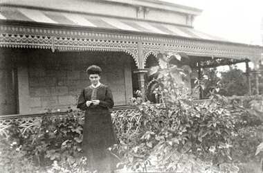 Photograph (Item) - Black and White, Lady in front of Victorian house