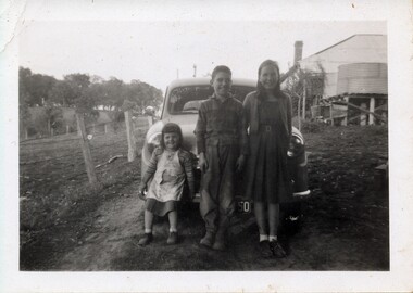 Photograph - Scanned photograph of Horrie Smith's house in Homestead Road Wonga Park, “Old Home at Wonga Park” Photo is of the rear of the house with 3 children in front of the care. Homestead road is behind the fence line before the trees running from the left of the photo towards the house