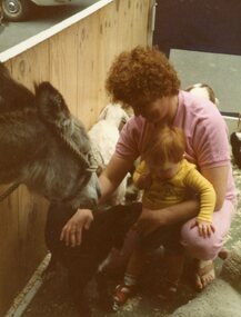Photograph, POCH & LC Playgroup visiting the animal farm 1984, with Maree & Kieran Phillips patting a dog and donkey