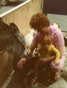 Photograph, POCH & LC Playgroup visiting the animal farm 1984, with Maree & Kieran Phillips patting a dog and donkey