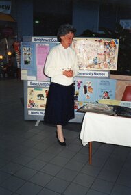 Photograph, Lady speaking at a display (POCH)
