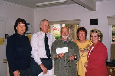 Photograph, Presentation of a cheque at the Community House (POCH)