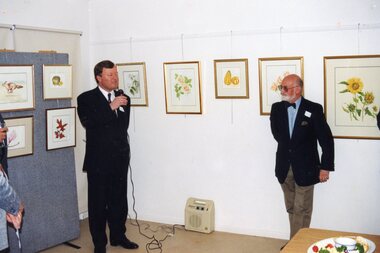 Photograph, Official talking to a crowd at the Community House (POCH)