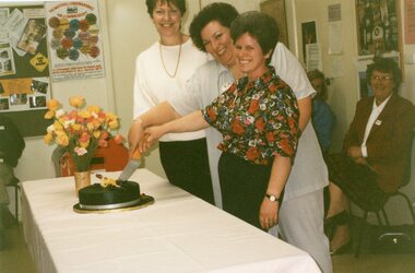 Photograph, Two ladies ceremoniously cutting a cake at Park Orchards Community House