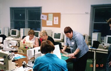 Photograph, Ladies on sewing machines at the Park Orchards Community Centre