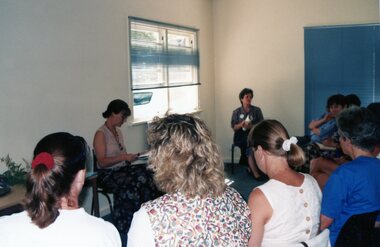 Photograph, Lady talking to a group of people at Park Orchards Community Centre, Unknown year
