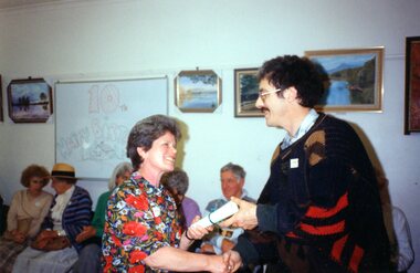 Photograph, Lady presenting a certificate to a man at Park Orchards Community Centre, Unknown year