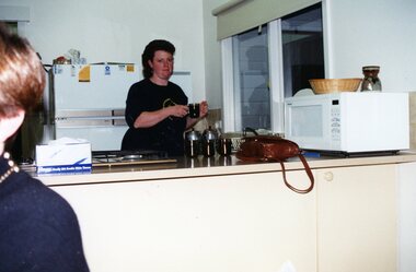 Photograph, Lady making a cuppa at Park Orchards Community Centre, Unknown year