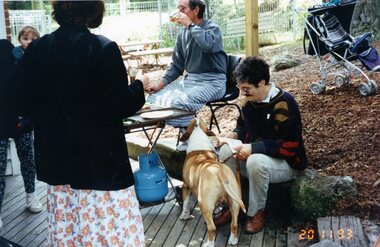 Photograph, People and a dog enjoying food at Park Orchards Community Centre, 20th November 1993
