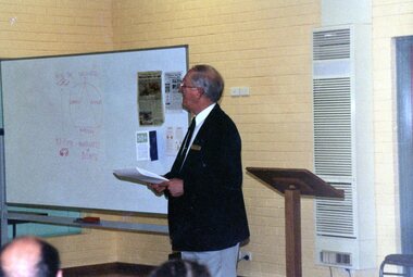 Photograph, Man giving a lecture at Park Orchards Community Centre, Unknown date