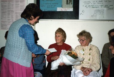 Photograph, Lady getting birthday flowers and card at Park Orchards Community Centre, Unknown date