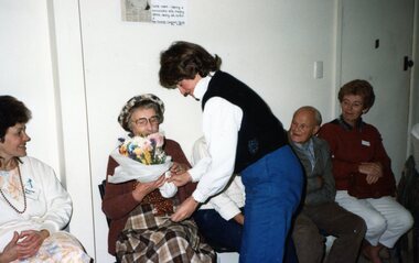 Photograph, Lady getting presented with flowers at Park Orchards Community Centre, Unknown date