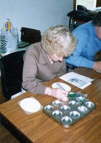 Photograph, Jean Hepstead making plaques for Christmas cakes at Park Orchards Community Centre, Unknown date