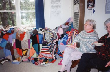 Photograph, Ladies and a big pile of quilts at Park Orchards Community Centre, Unknown date