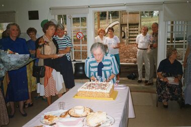 Photograph, Older lady blowing out cake at Park Orchards Community House, Unknown date