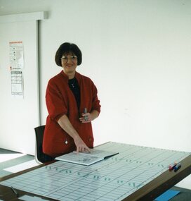 Photograph, Staff member planning schedule at Park Orchards Community House, Unknown date