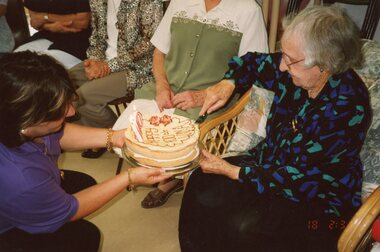 Photograph, Vima cutting her 100th birthday cake at Park Orchards Community House, Circa 2004