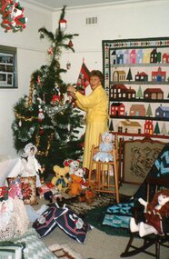 Photograph, Lady decorating a Christmas tree at POCH, Unknown date