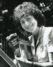 Photograph, POCH class instructor holding dictionary and thesaurus, Unknown date
