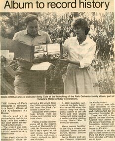 Newspaper, History book on display at the Park Orchards Community House, with Doug Upham and Betty Cole in 1985