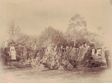 Group of riders with penny farthings.