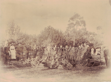 Group of riders with penny farthings.