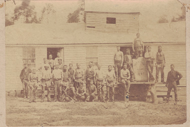 Group of shearers standing outside a shearing shed.