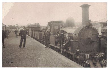 Postcard of men standing on platform beside steam engine R327 at Linton Railway station and two young men sitting on the side front platform.