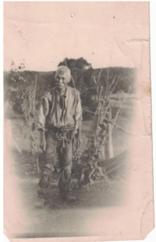 Chinese man wearing ragged clothing.