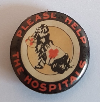 Round badge with a rescue dog in the centre.