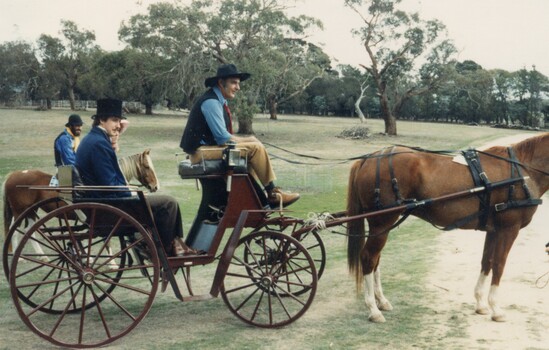 People in a horsedrawn carriage.