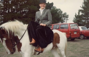 Woman riding a horse.