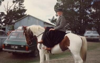 Woman riding a horse.